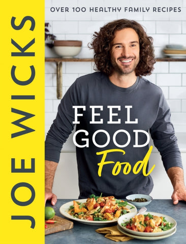 Book cover of Feel Good Food : Over 100 Healthy Family Recipes by Joe Wicks. Photograph of author in a kitchen, serving food, on a table.