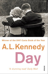 Day by A.L. Kennedy. Book cover has a black and white photograph taken from behind, of a young couple sat together on a park bench 