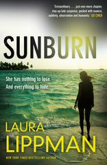 Sunburn by Laura Lippman. Book cover has a photograph of a woman standing on a beach in the surf, on a tropical island, with two boats in the distance.