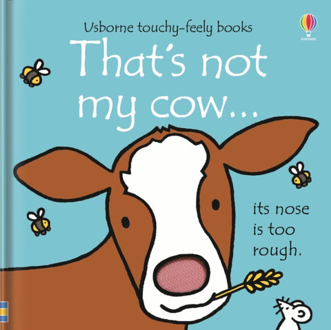 That's not my cow… by Fiona Watt. Book cover has an illustration of a cow chewing straw, a mouse and three bee's on a blue background.