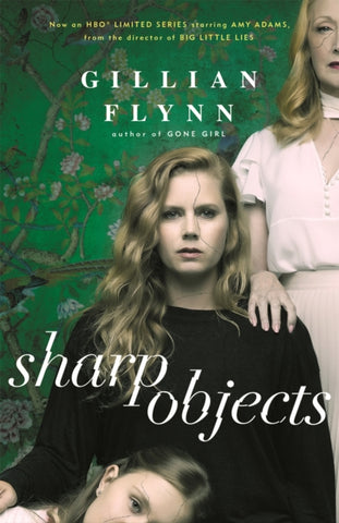 Sharp Objects by Gillian Flynn. Book cover has a photograph of two women and a young girl with a green floral wall paper in the background.