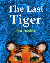 The Last Tiger by Petr Horacek. Book has an illustration of a tiger with green eyes on a blue leafed patterned background.